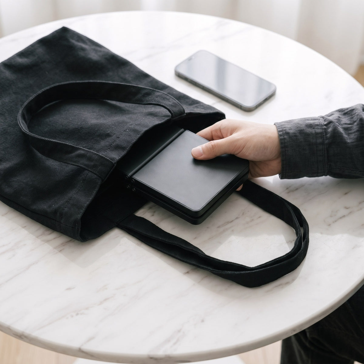 Keyboard folded to phone size, sliding into a bag