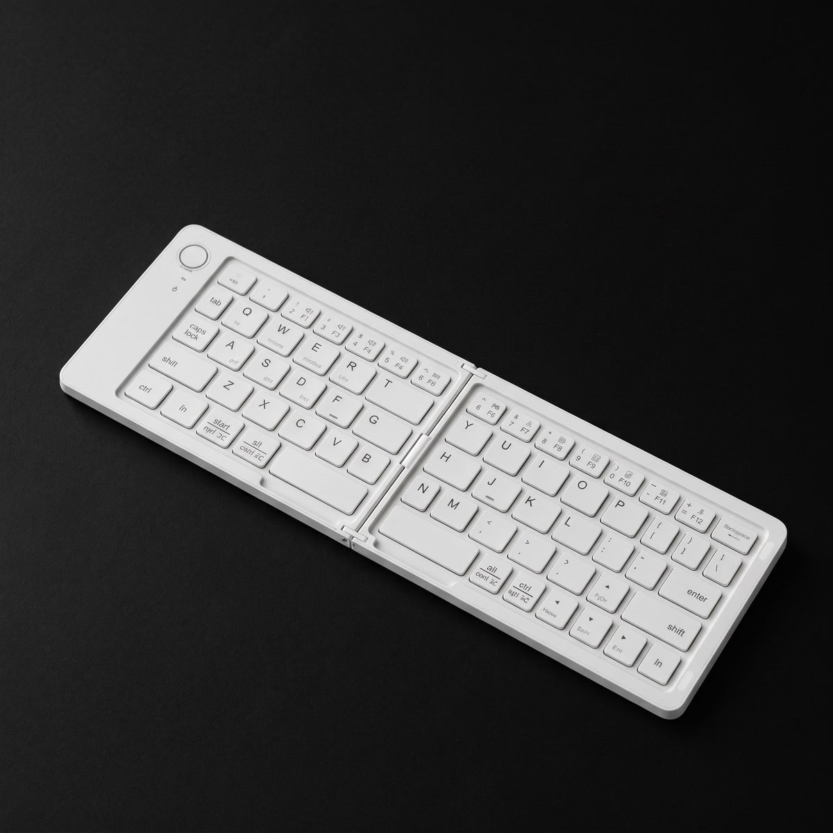 White foldable Bluetooth keyboard on black