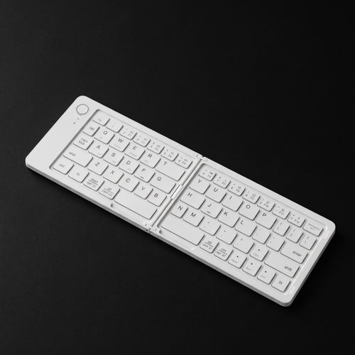 White foldable Bluetooth keyboard on black